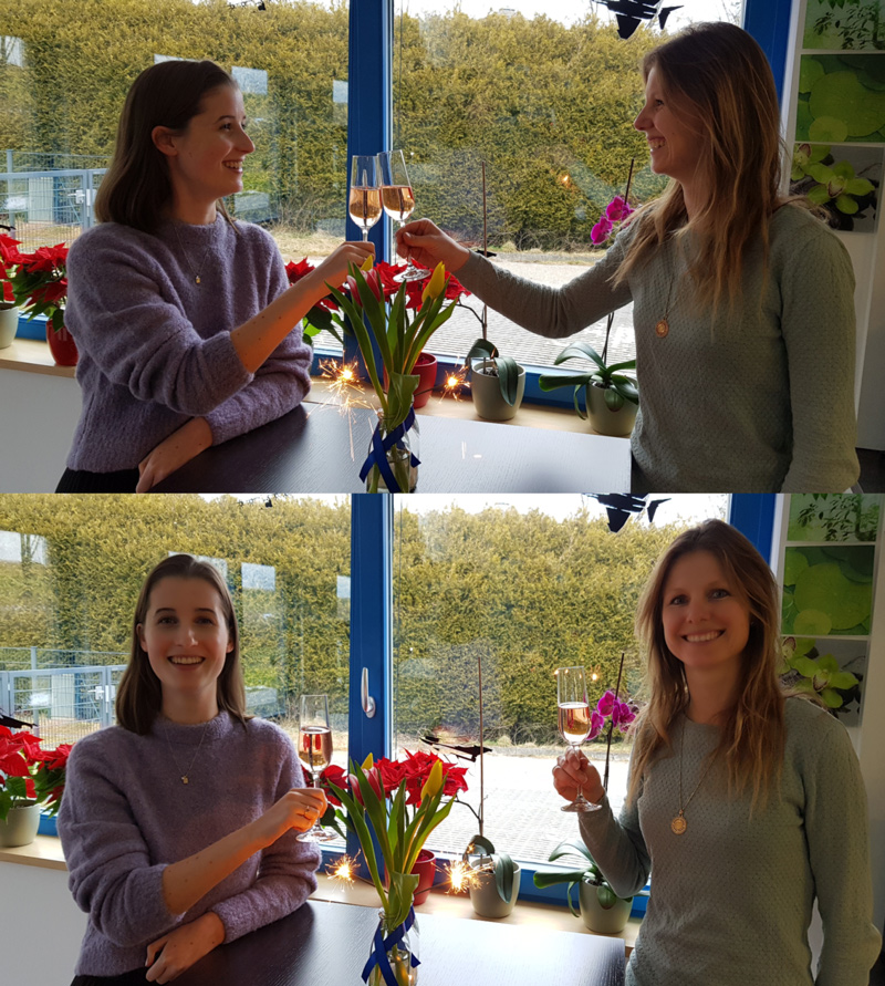 Two colleagues raising a glass to the new year in the office