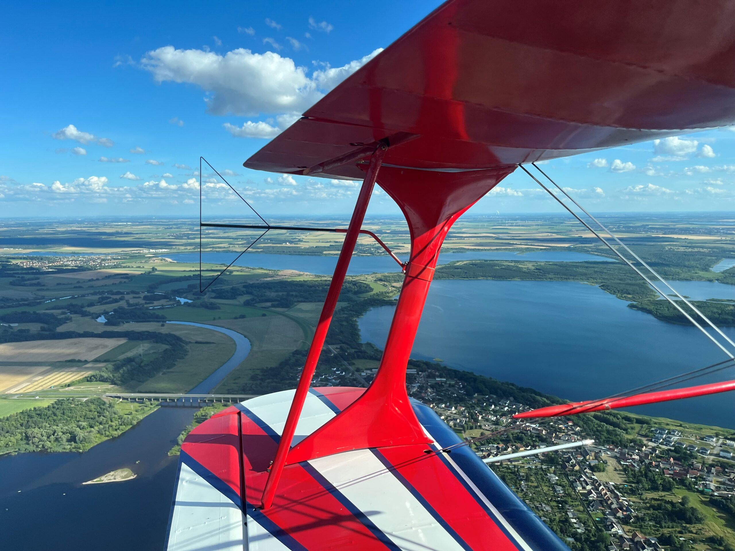 View across the wing onto a lake during the flight