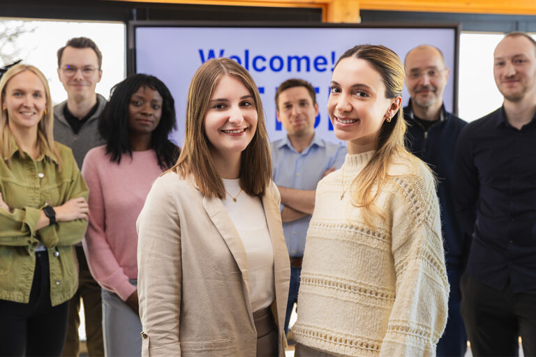 New colleagues in front of the welcome display