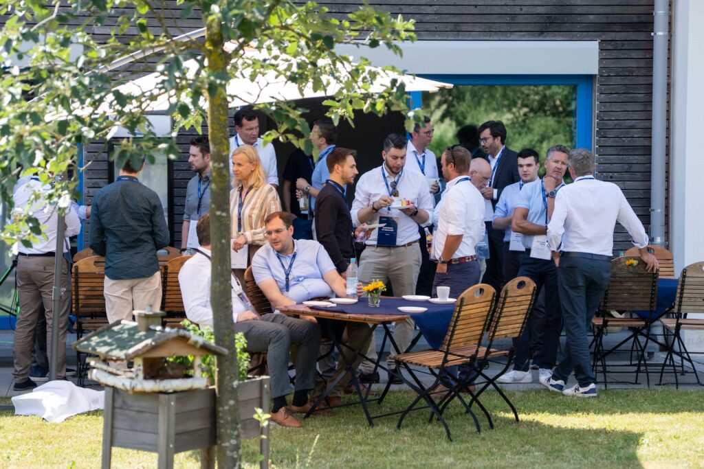 Guests networking outdoors during the Experience Day