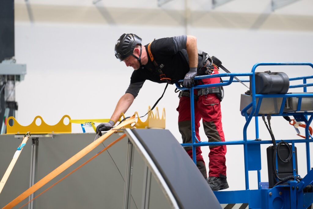 Technician working on the dome of a REISER simulator in production