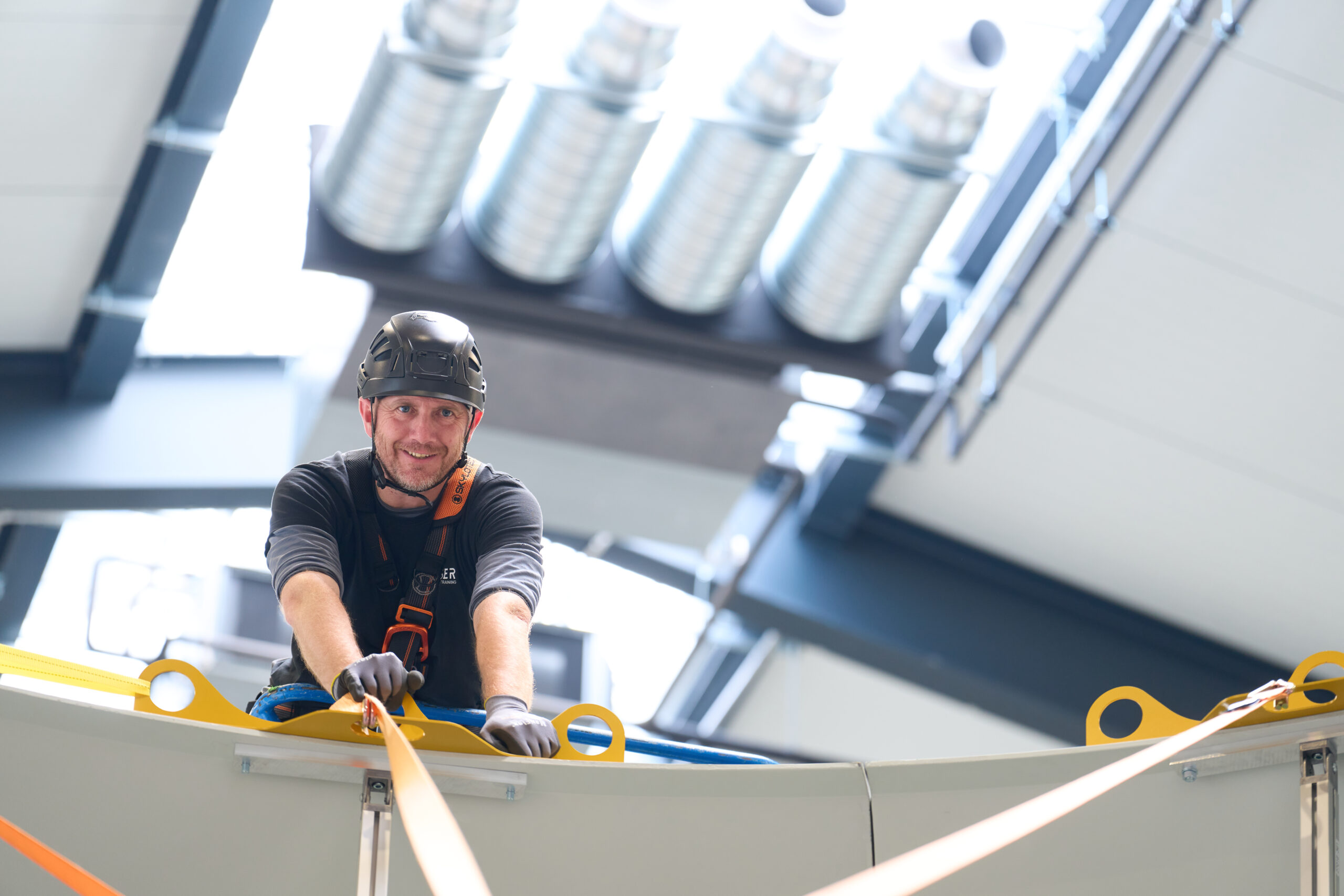 Team member working on the projection dome under the hall lighting