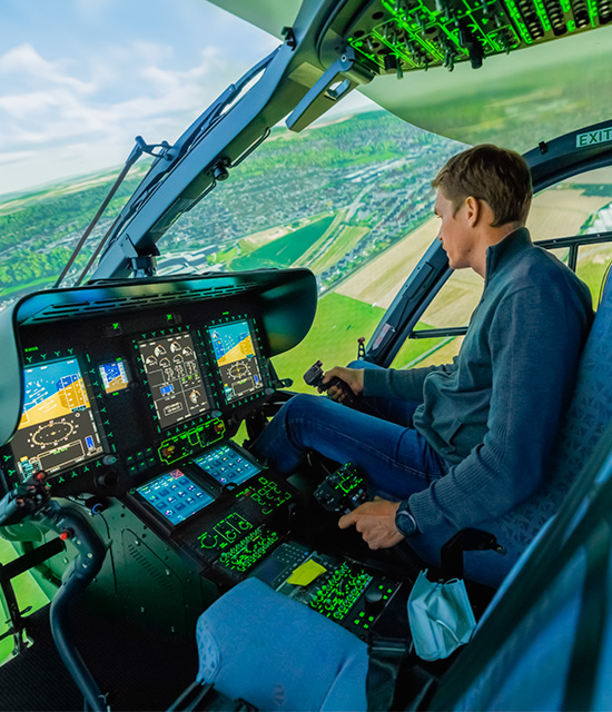 Team member flying the helicopter simulator