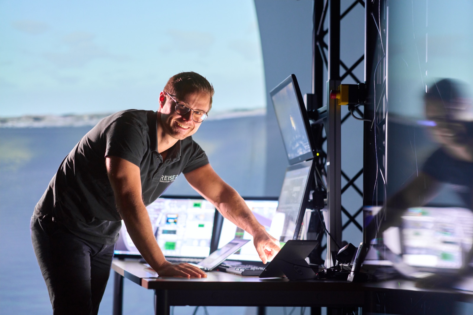 Engineer at the control station of a simulator in the projection dome