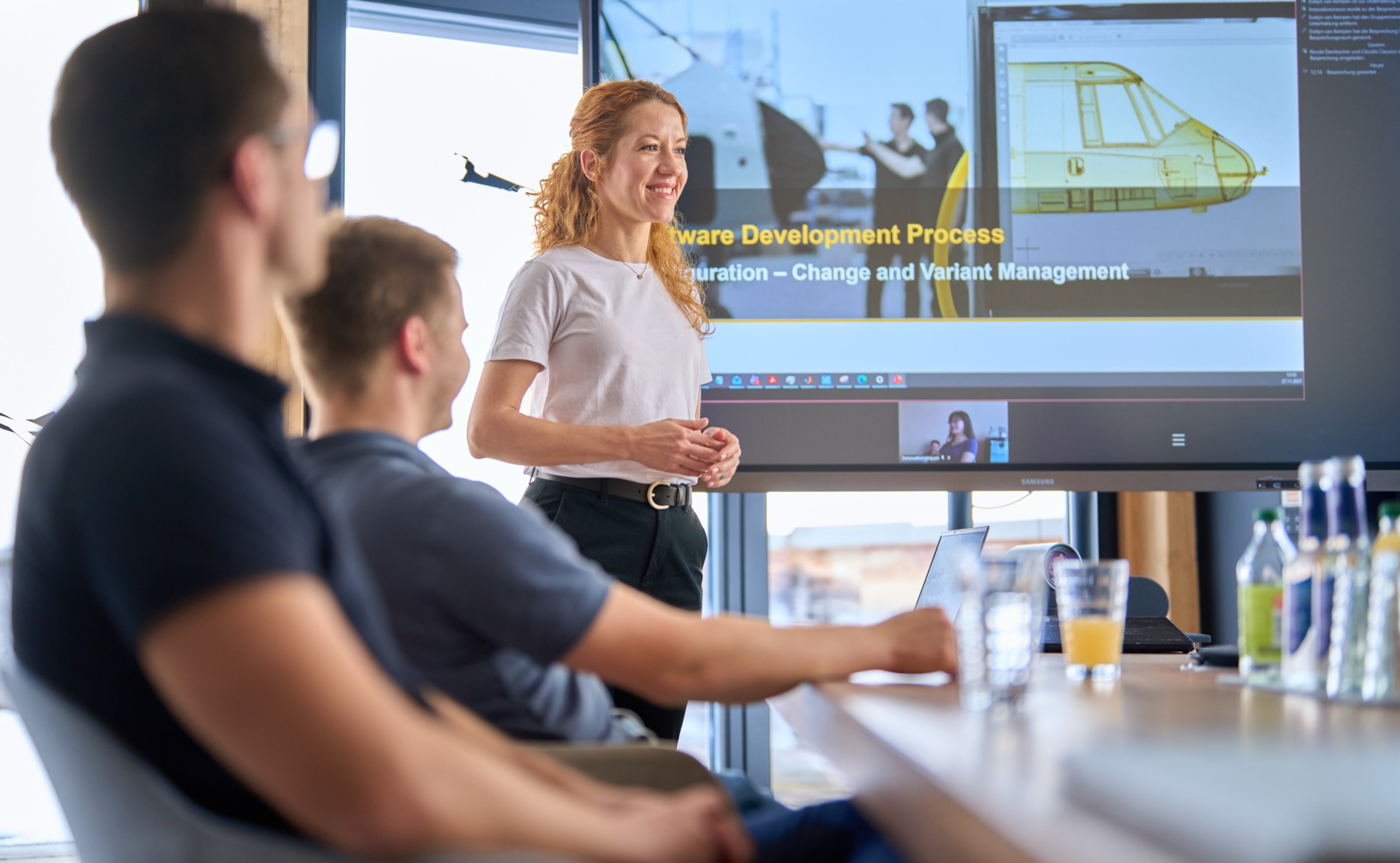 Colleague presenting to team members in the meeting room