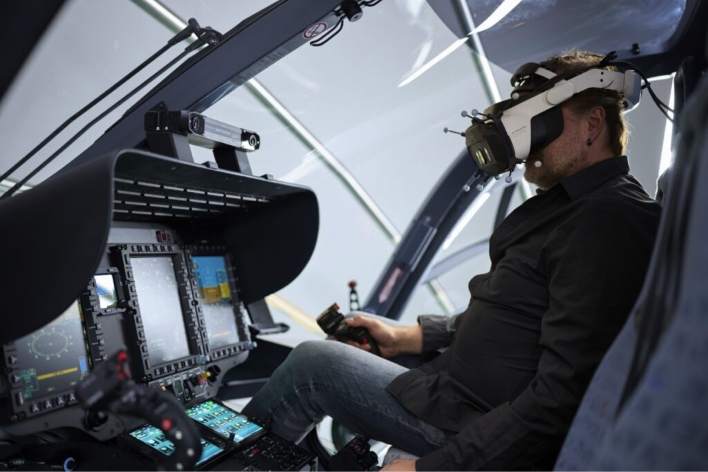 Pilot wearing a mixed reality headset in the simulator cockpit